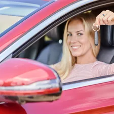 Teen standing beside car